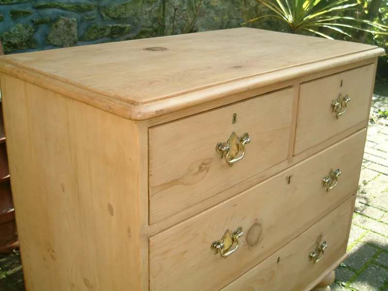 Front image of antique pine chest, with floral decoration