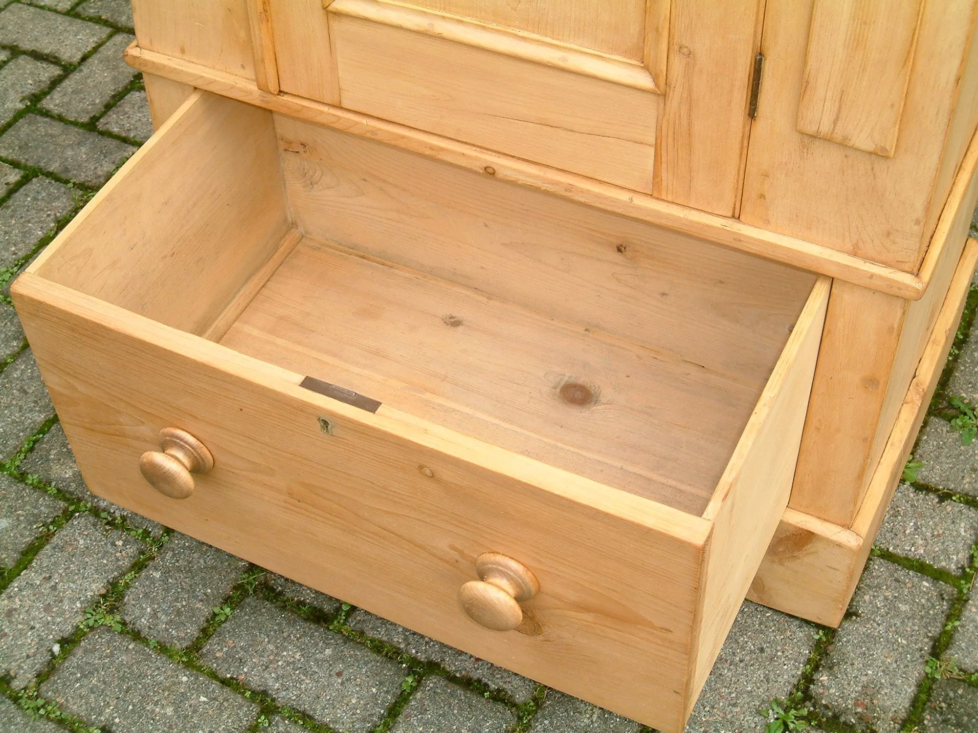 image showing open base drawer on old pine wardrobe