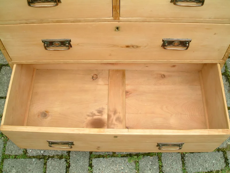 Image of the bottom drawer open on the old pine chest