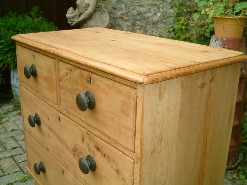 Image of the top of the antique pine chest of drawers, showing the top bead