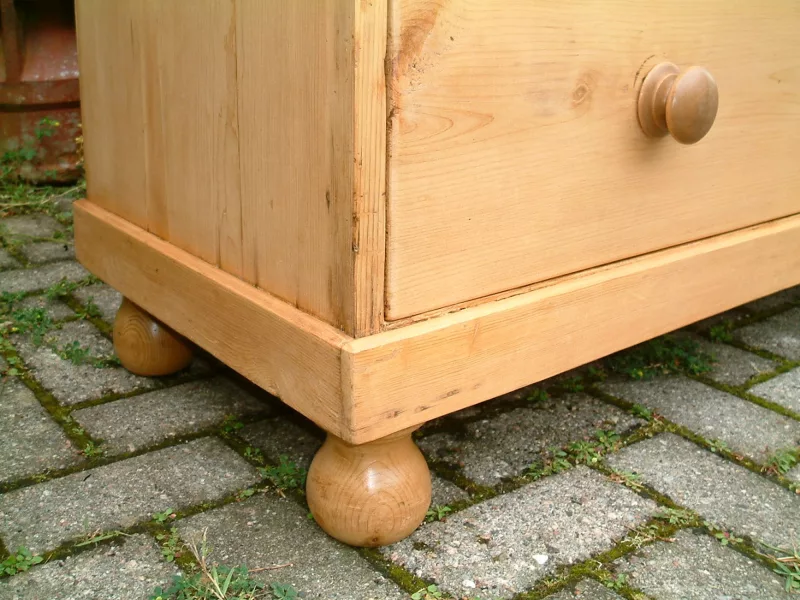 Image showing the turned ball feet and plinth on the antique pine chest.