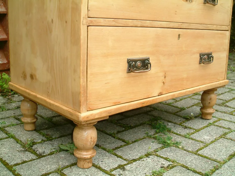 Close image of the turned supports on the Victorian pine chest of drawers