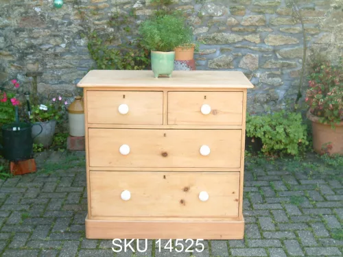 Front image of the antique pine chest of drawers with floral decoration.