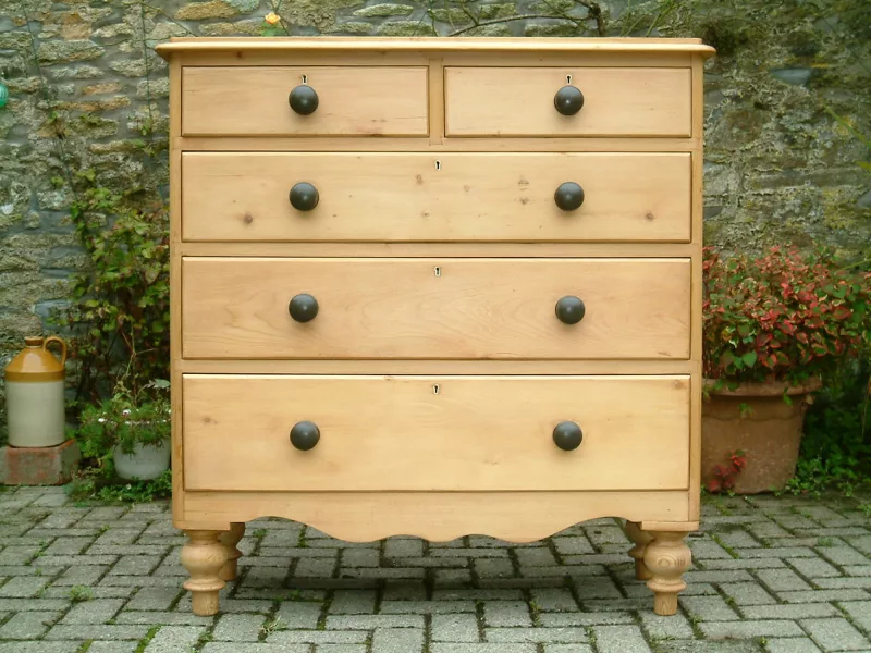 Close image of the antique pine chest of drawers.