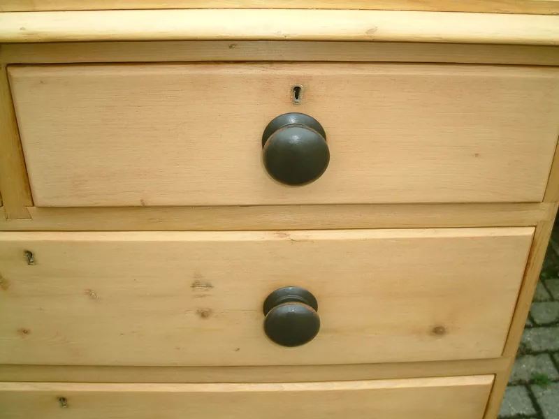 Close image of the knobs on the antique pine chest of drawers
