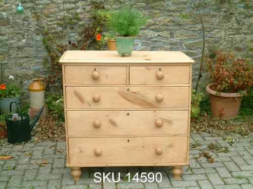 Front image of the antique pine chest of drawers with floral decoration.