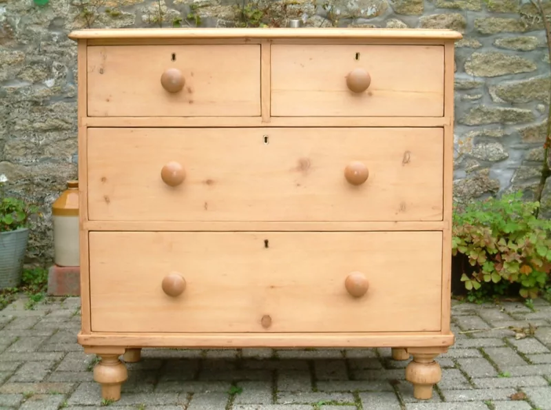 Close image of the front of the antique pine chest of drawers.