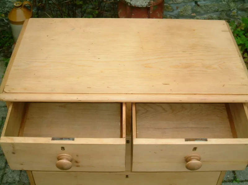 Image of the top drawers open showing timber bases on the antique pine chest of drawers.