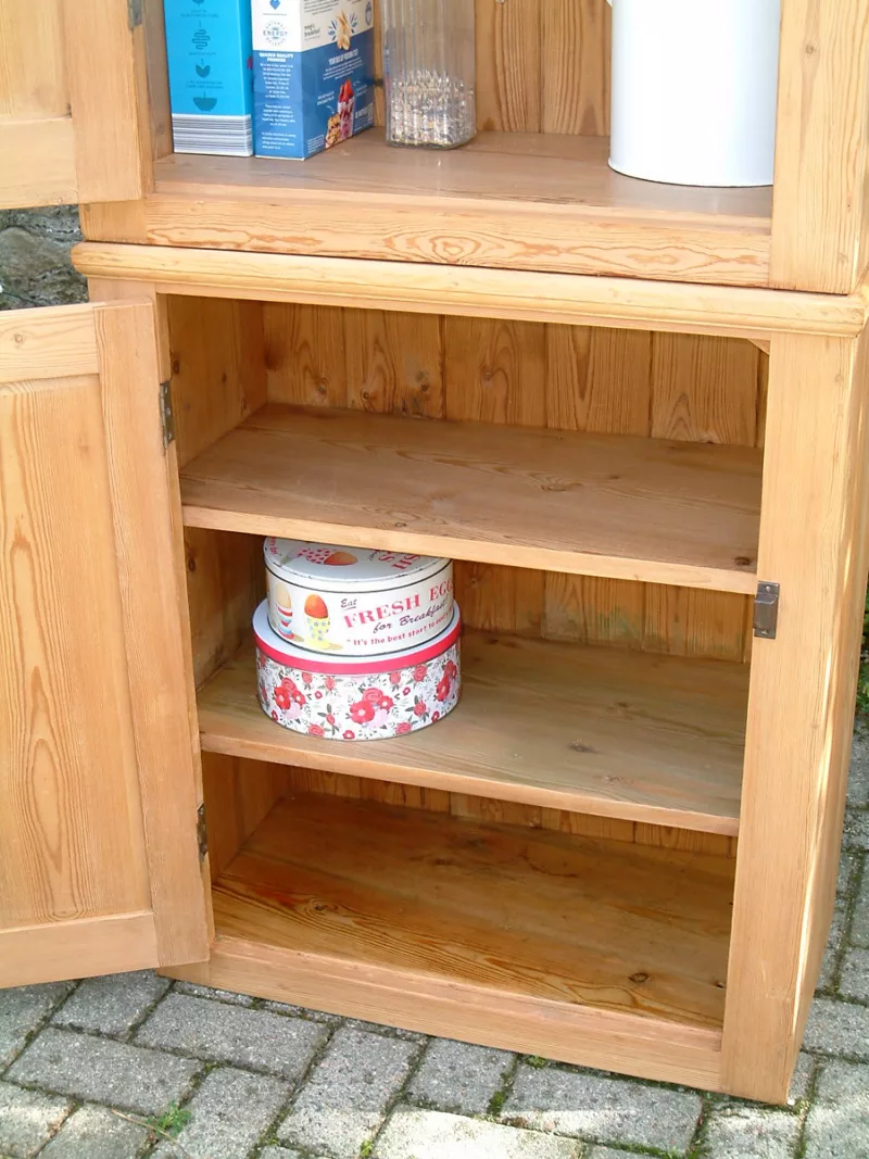 Image of the door open on the base of the vintage pine cupboard