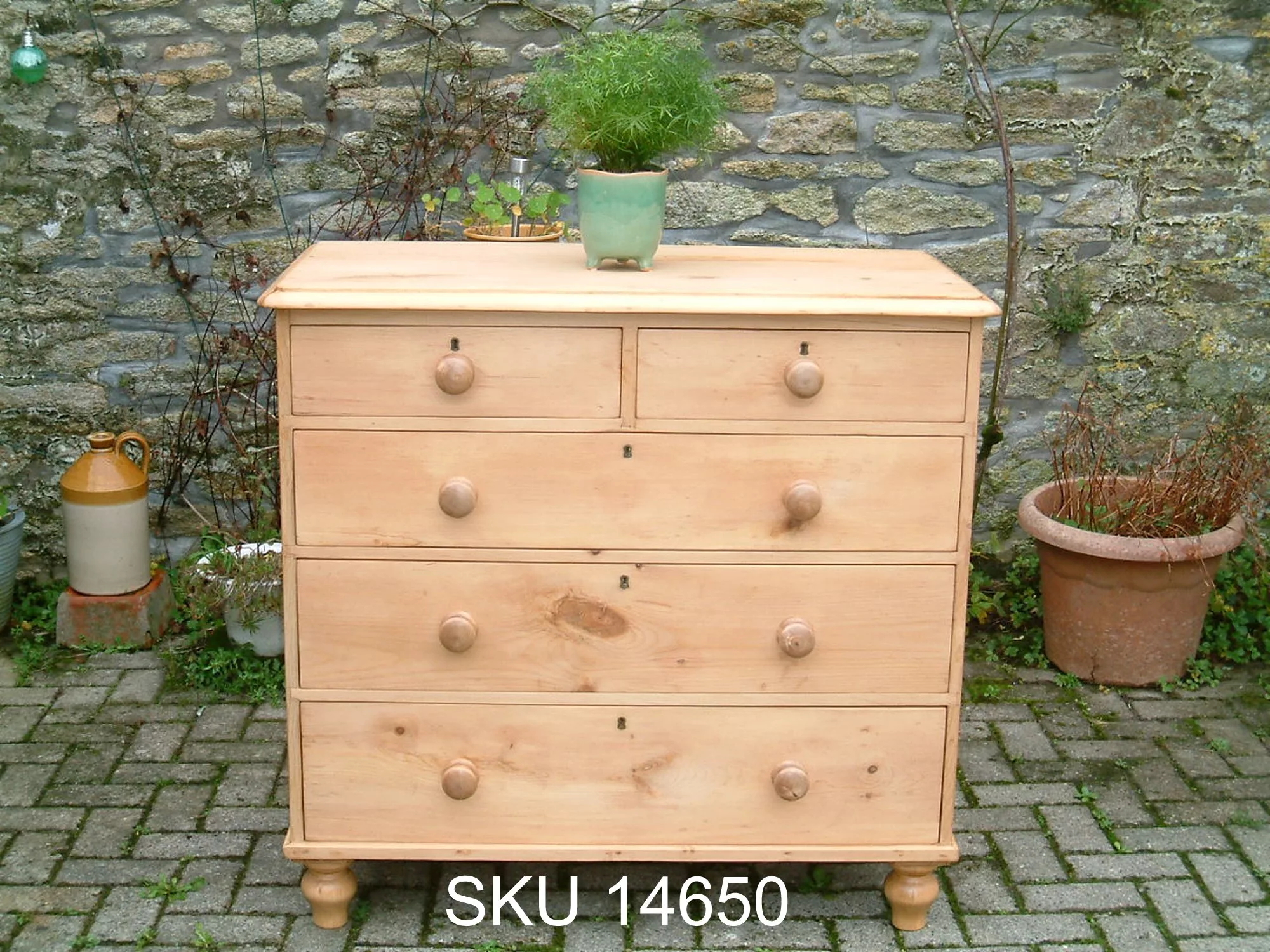 Close image of the front of the antique pine chest of drawers