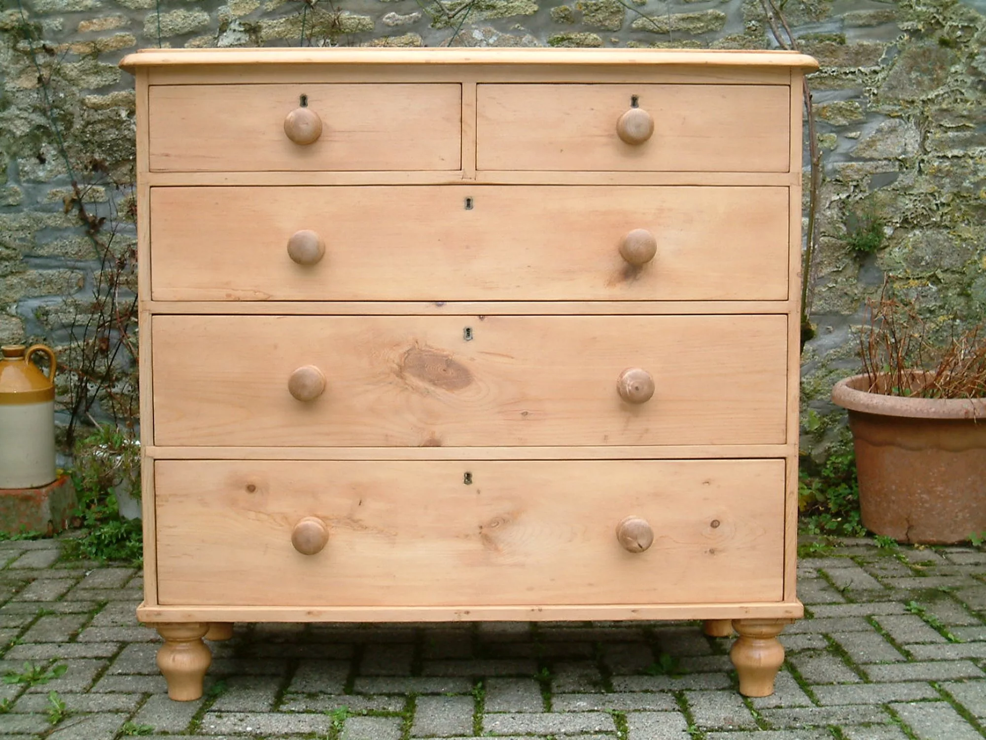 Close front image of the antique pine chest of drawers