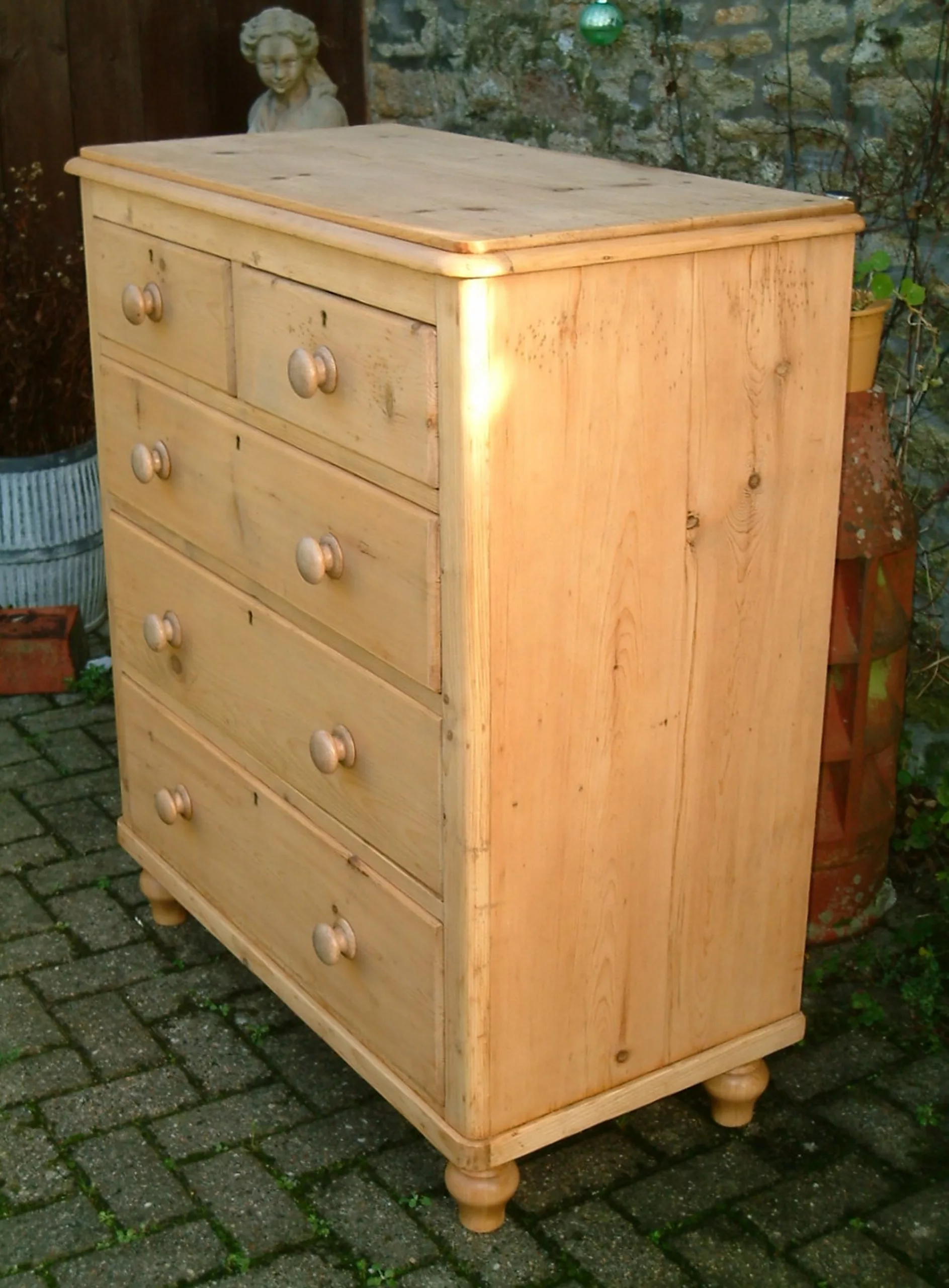 Image of the right side of the antique pine chest of drawers