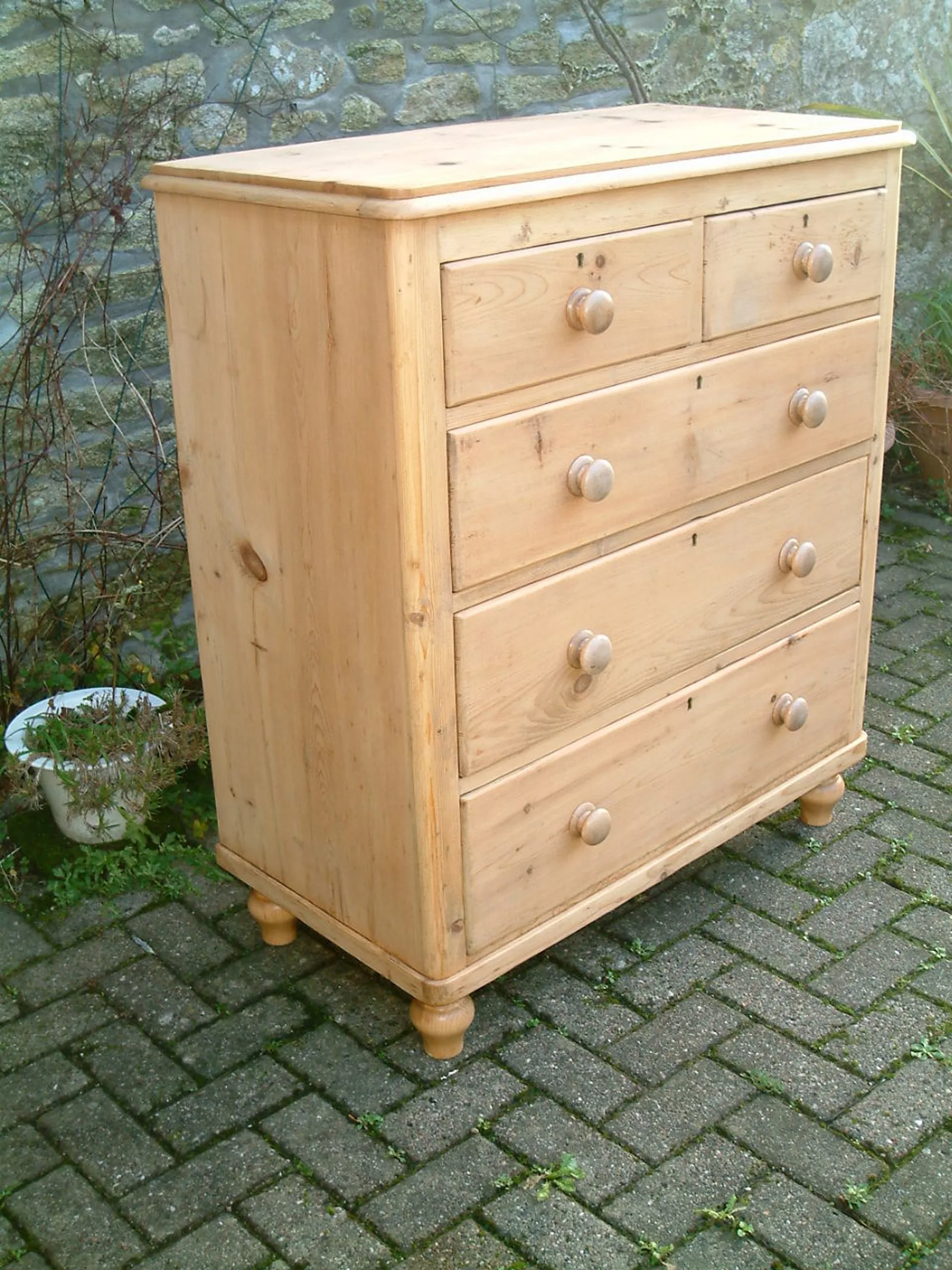 Image of the left side of the Vintage pine chest of drawers