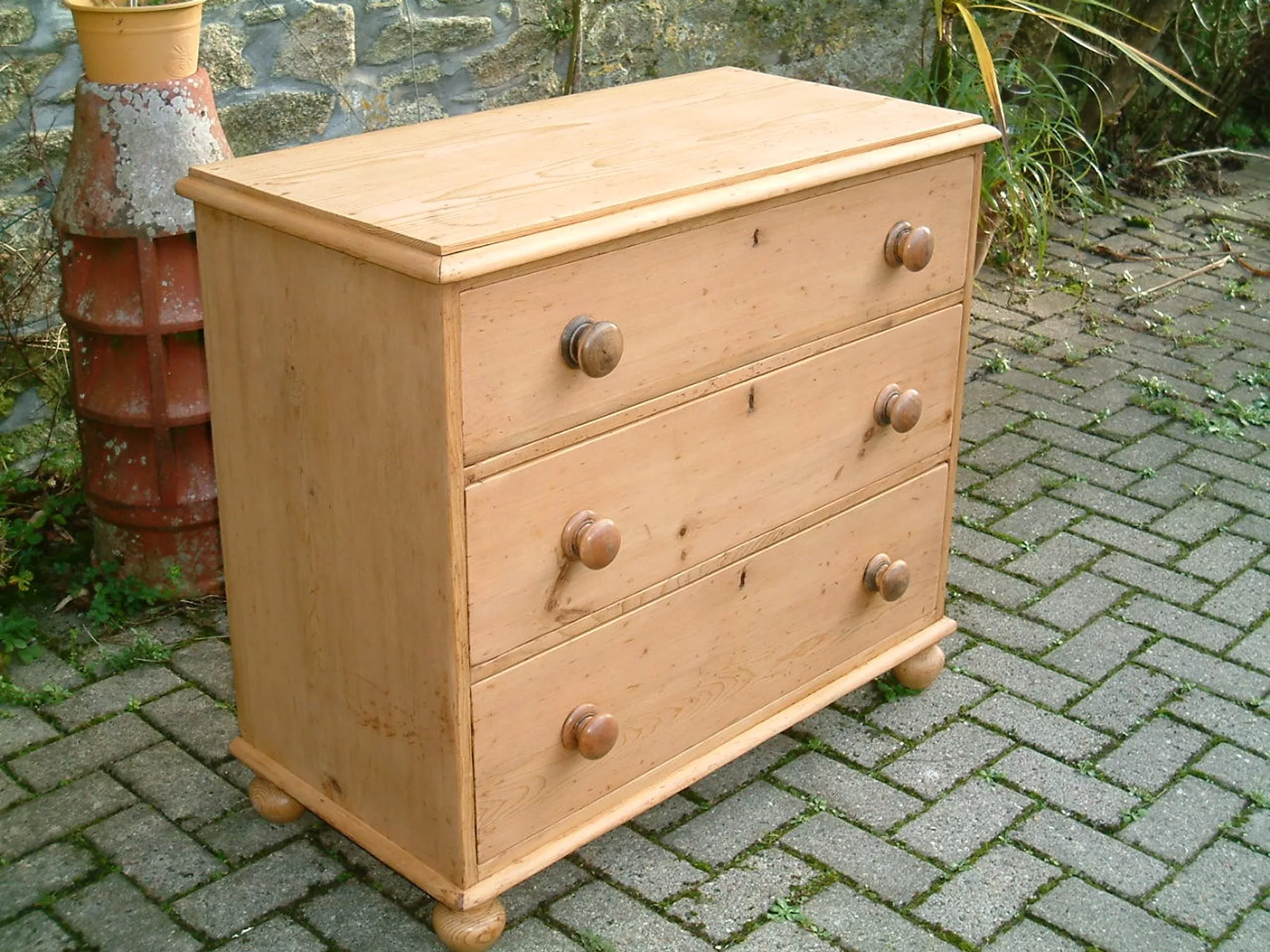 The left side of the antique pine chest and drawer fronts