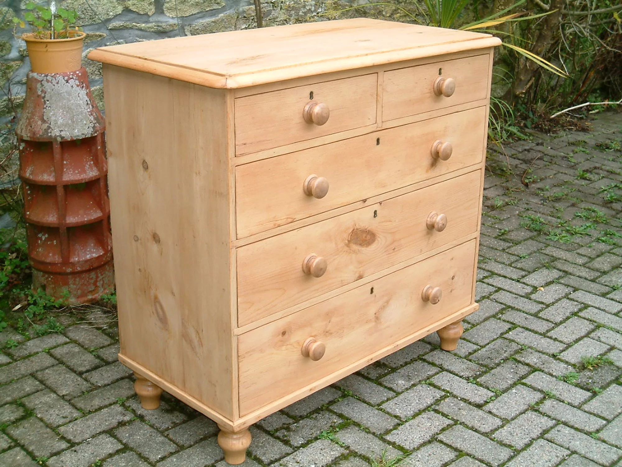 Image of the left side of the vintage pine chest of drawers