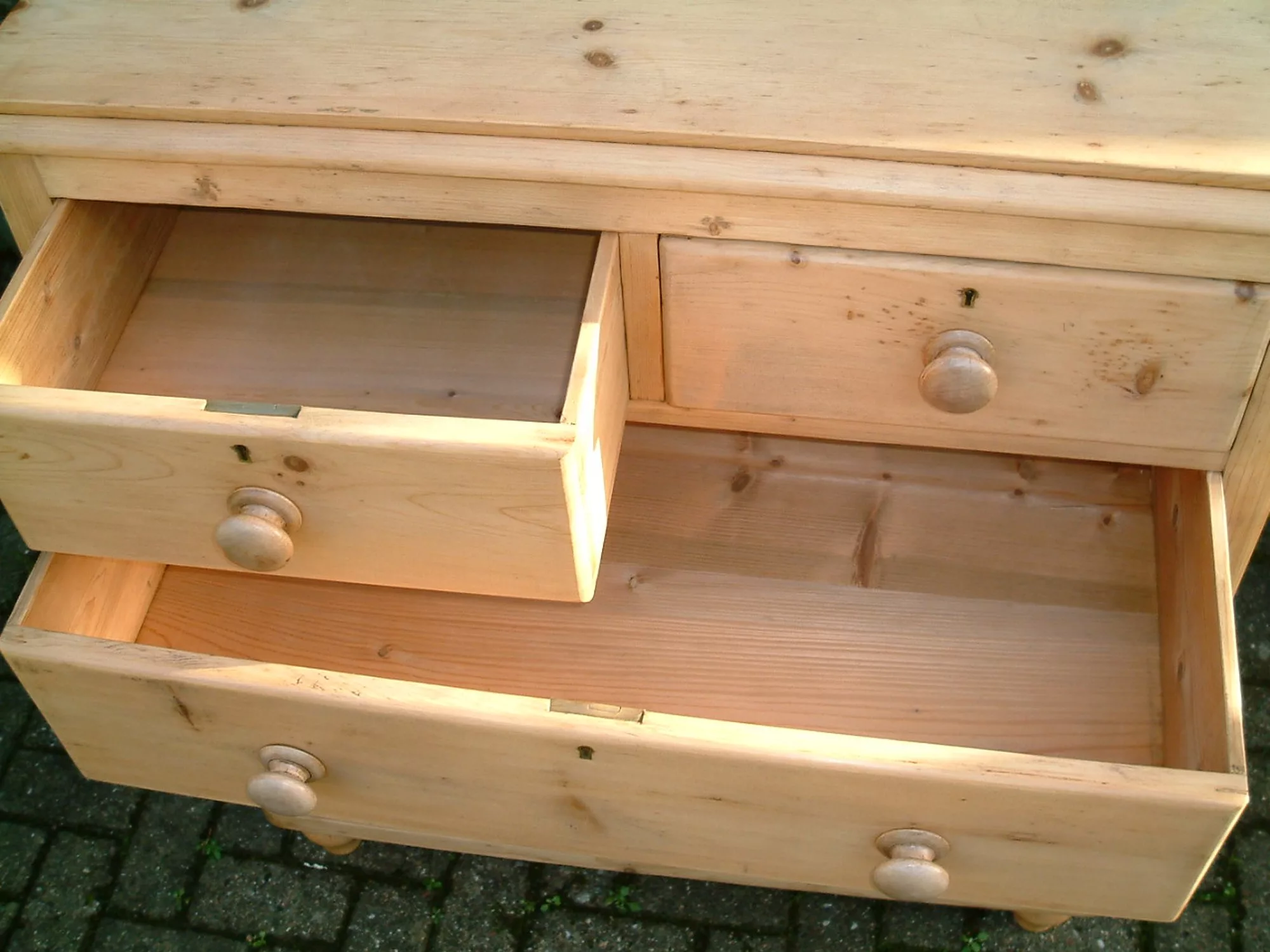 Image of the top drawers open on the old pine chest