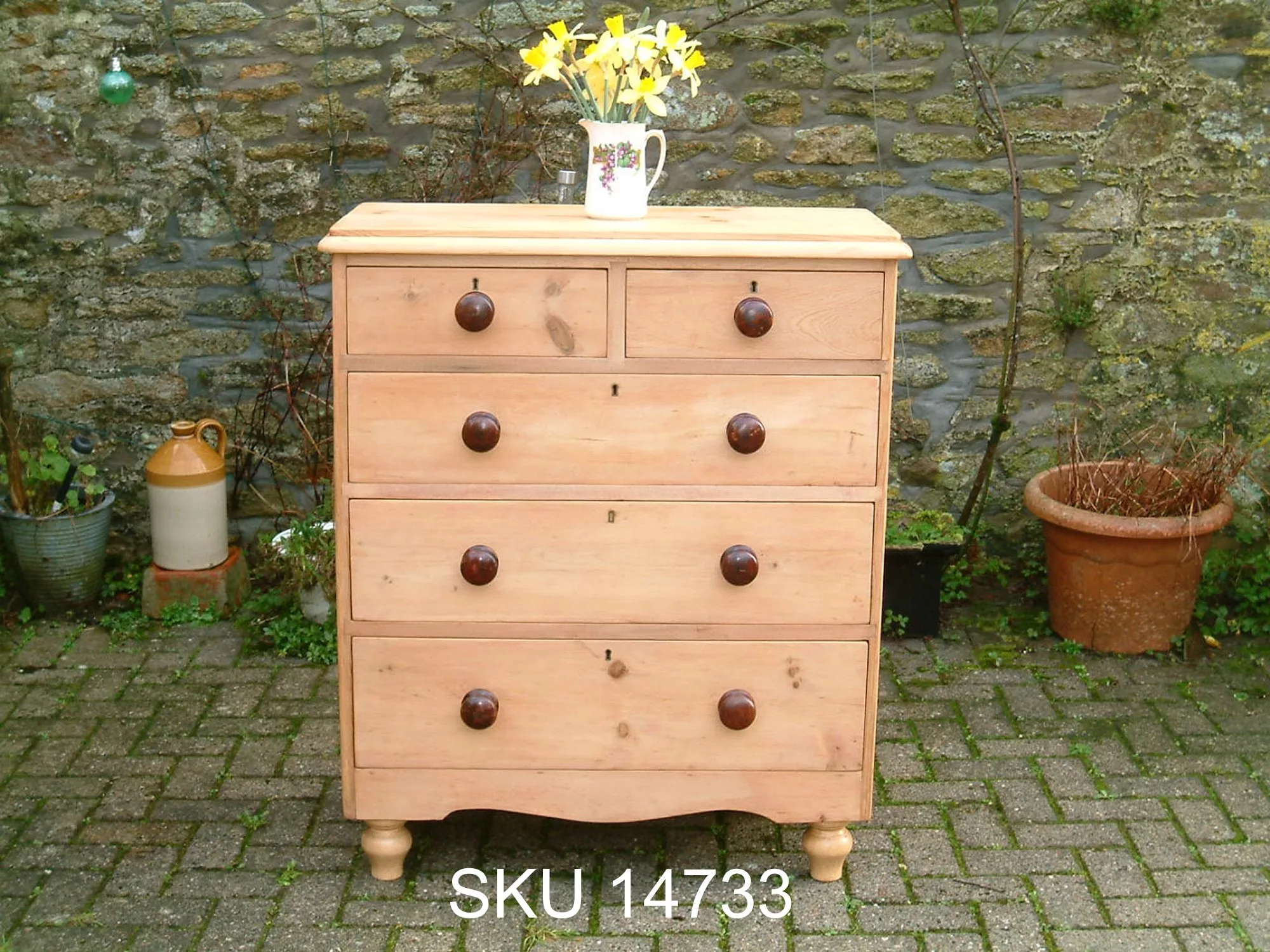 Front image of the antique pine chest of drawers, with floral decoration