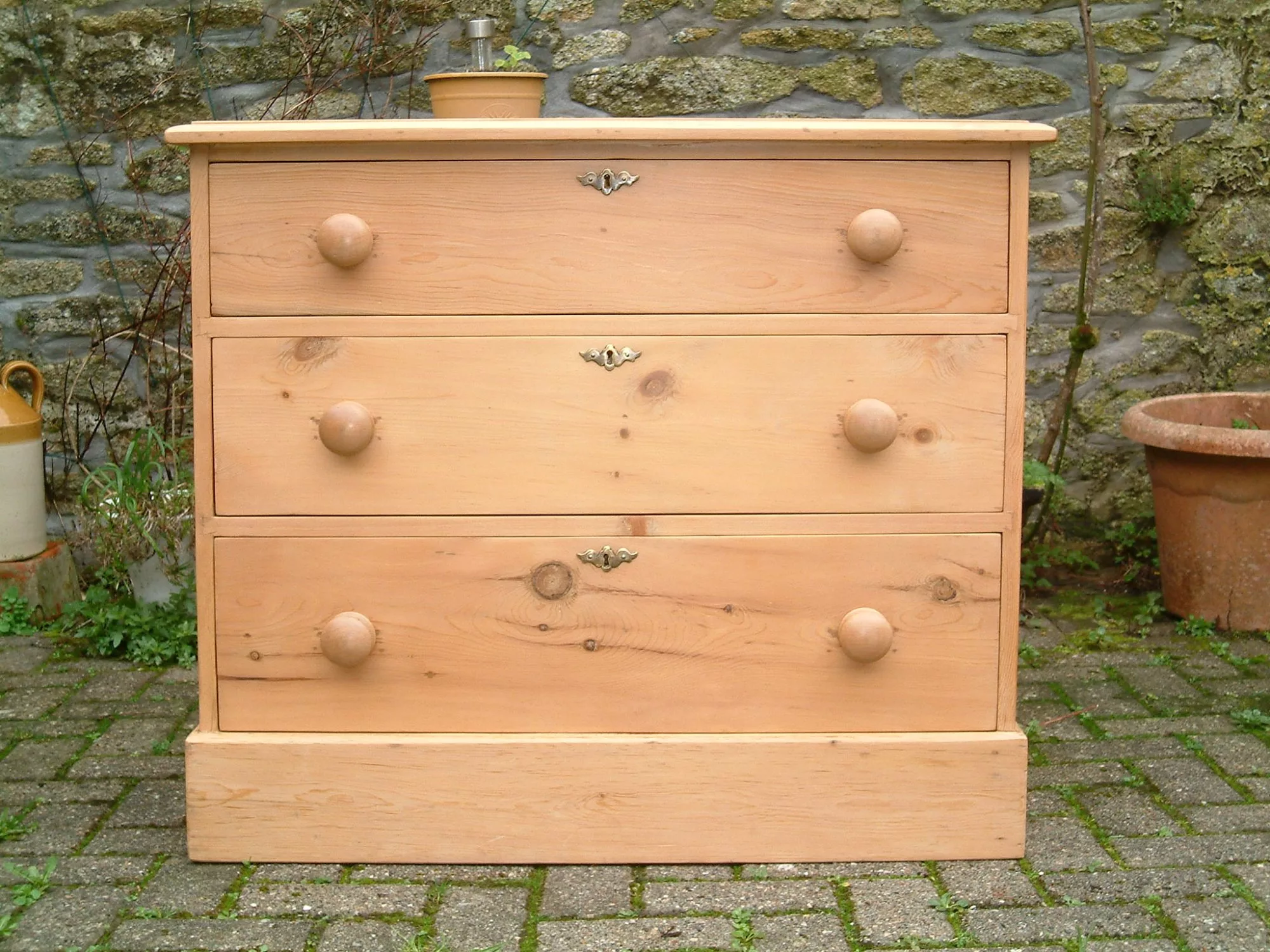 Close image of the front of the antique pine chest of drawers