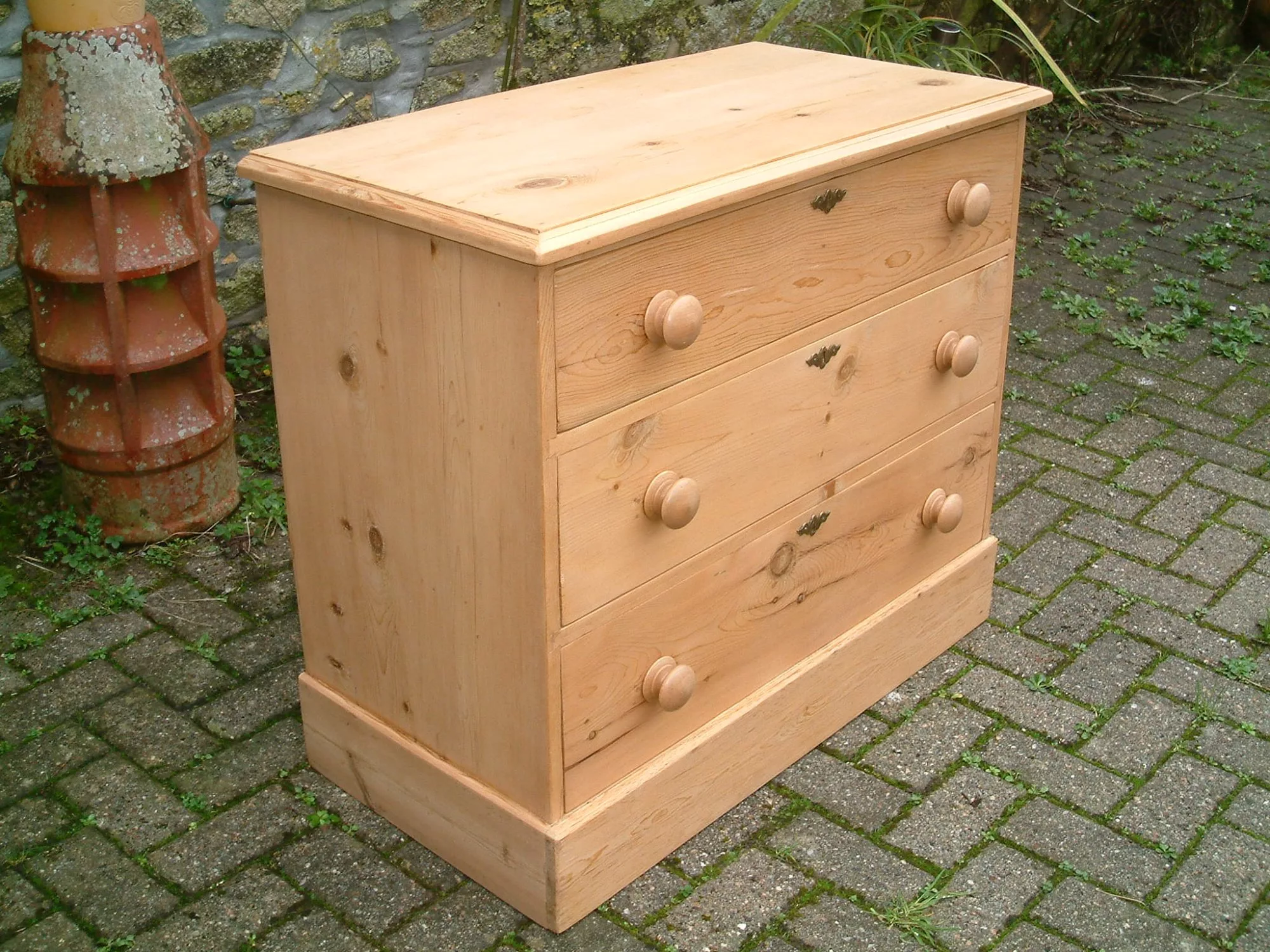 Image of the left side of the Victorian pine chest of drawers