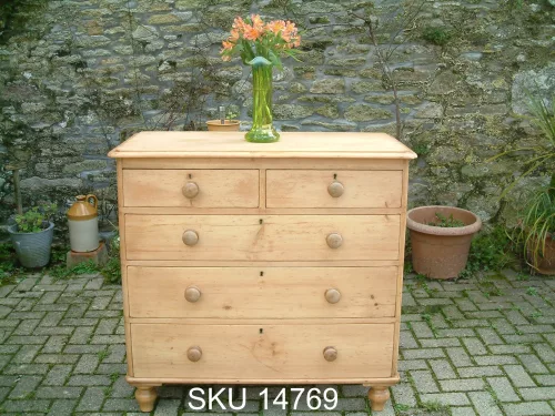Front image of the antique pine chest of drawers, with floral decoration.